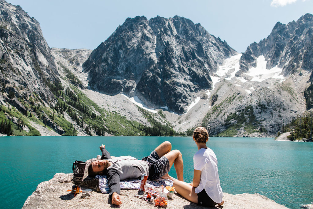 Couple relaxing at Colchuck Lake