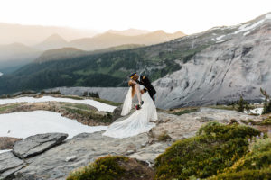 A groom embracing his bride during an elopement ceremony at Skyline Loop Mt Rainier