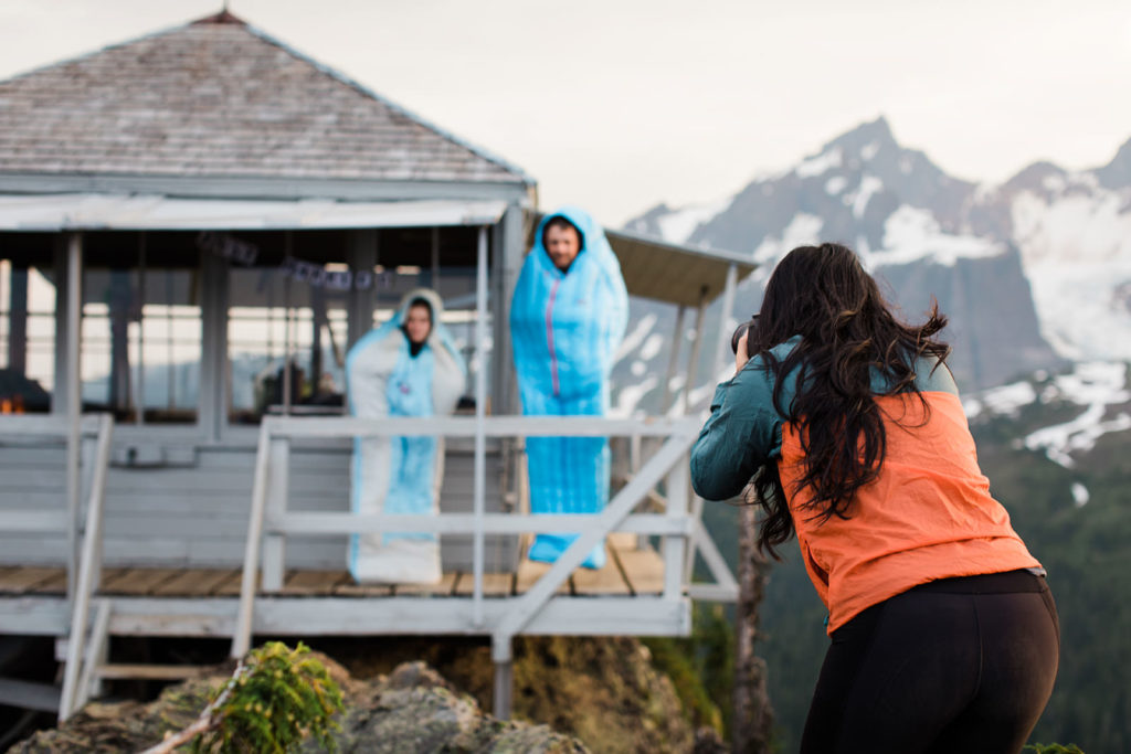 Elopement Photographer photographing couple in sleeping bags at Park Butte Lookout