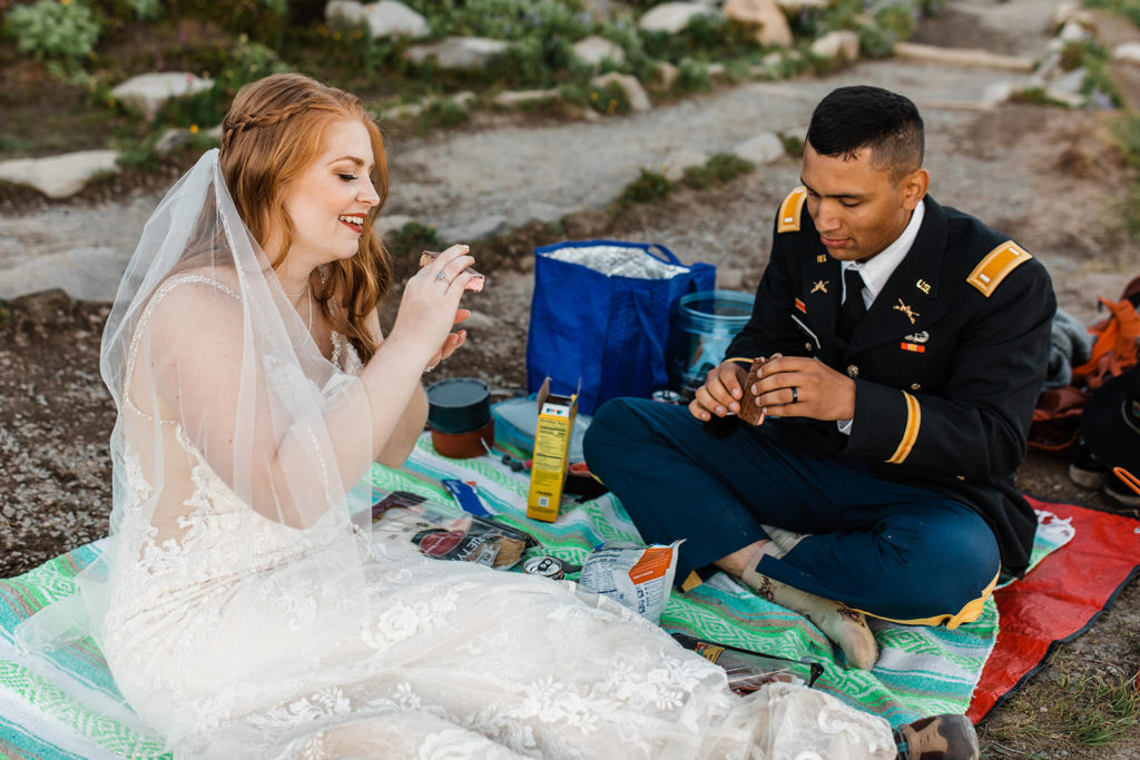 Bride and groom enjoying a meal during their hiking elopement