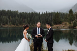 Bride and groom with their pastor getting married at Gold Creek Pond in Washington