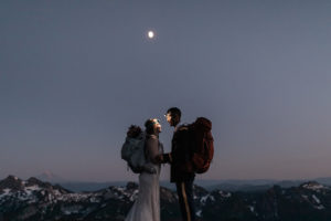 Newly married couple at blue hour looking at each other with headlamps on