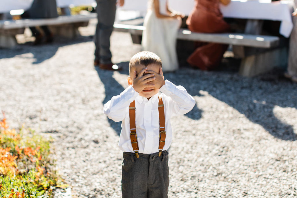 A ring bearer goofing off during his mom's elopement