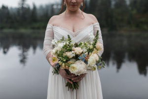 Bride holding her bouquet for her elopement at Picture Lake in Mt Baker