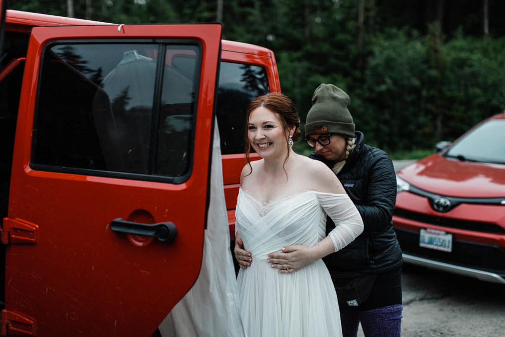 Bride & Groom getting into their red jeep