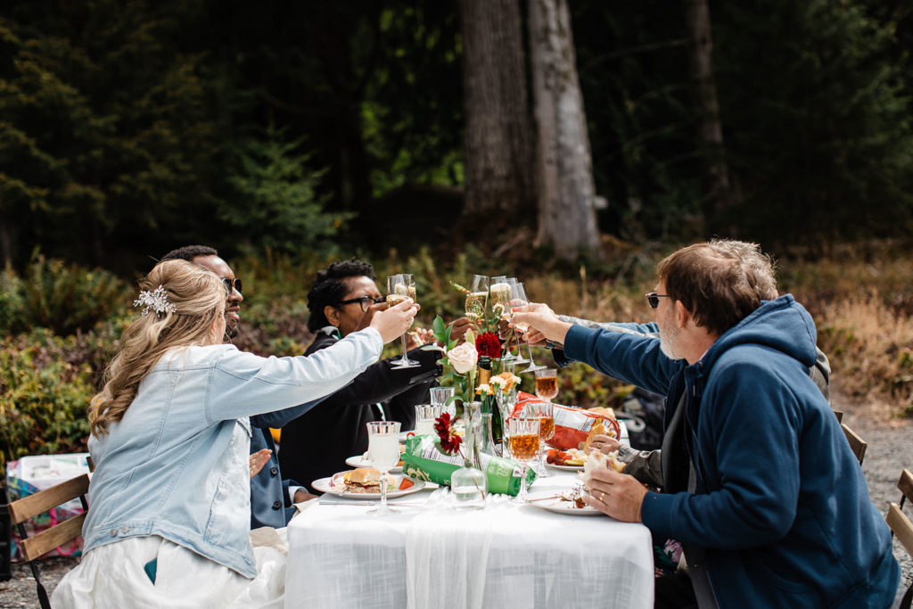 Friends toasting during a Lake Crescent elopement