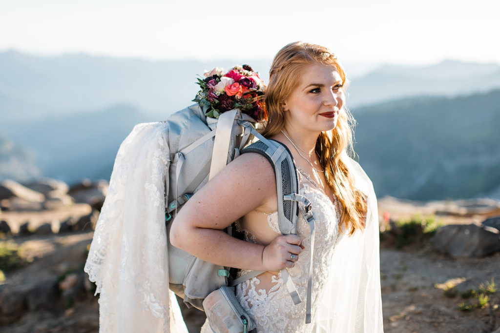 Rock climber bride with bouquet and hiking gear