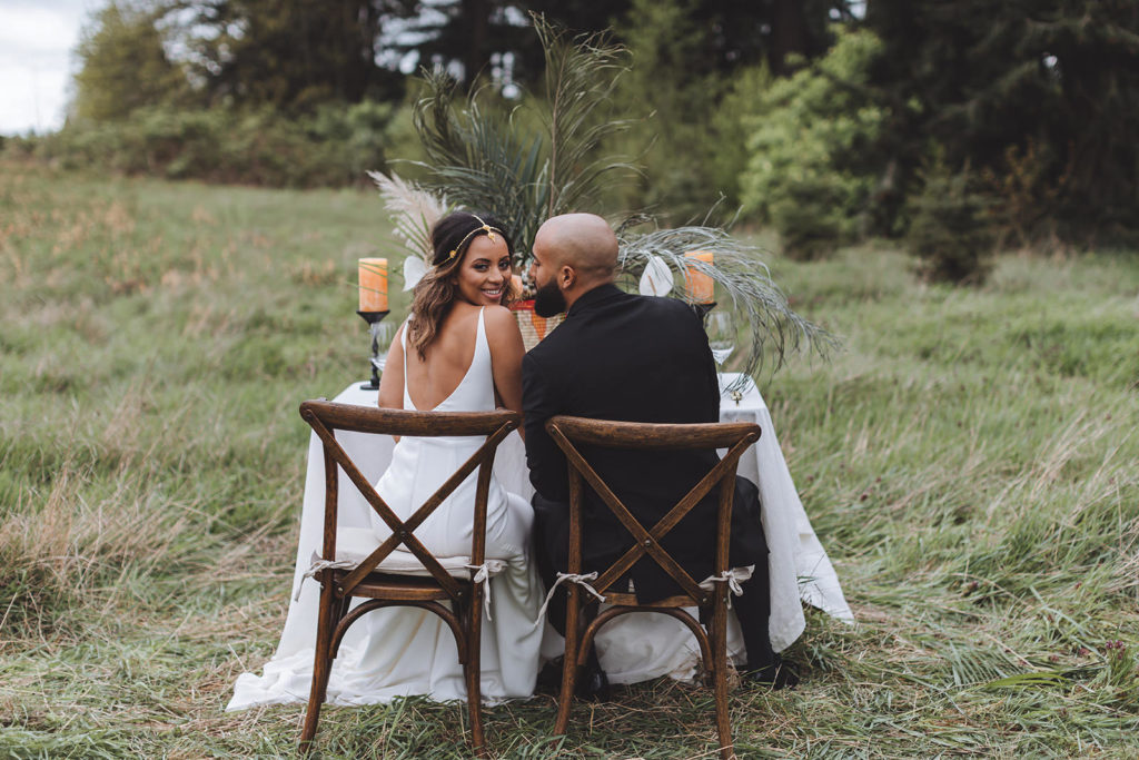 Eritrean bride and her groom sitting at their wedding table in Discovery Park, Washington
