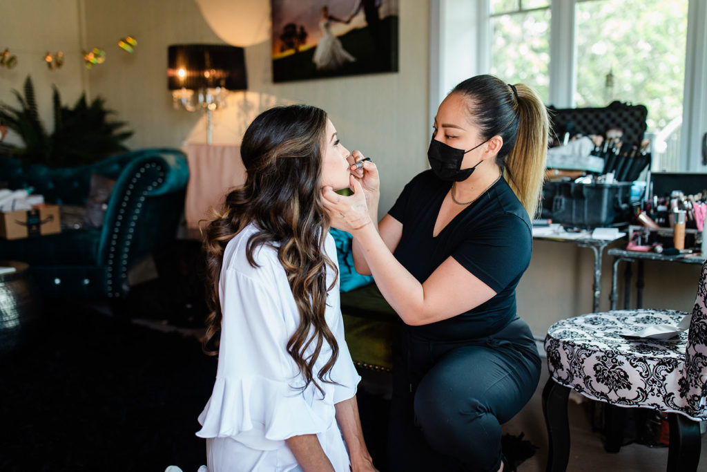 Makeup artist working on a bride before her elopement