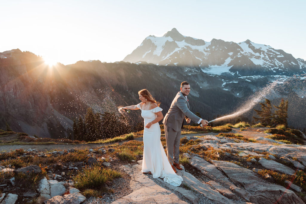 Newlyweds popping champagne after their elopement at Artist Point