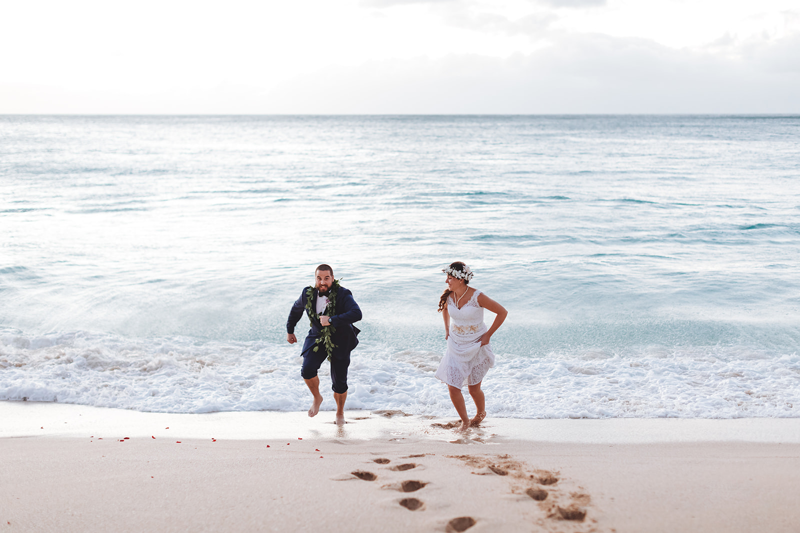 Newlyweds Paul & Kaitlyn running on the beach during an elopement photography session