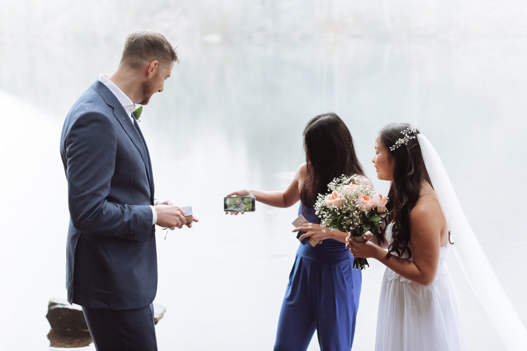 Couple with sister as officiant at their outdoor elopement